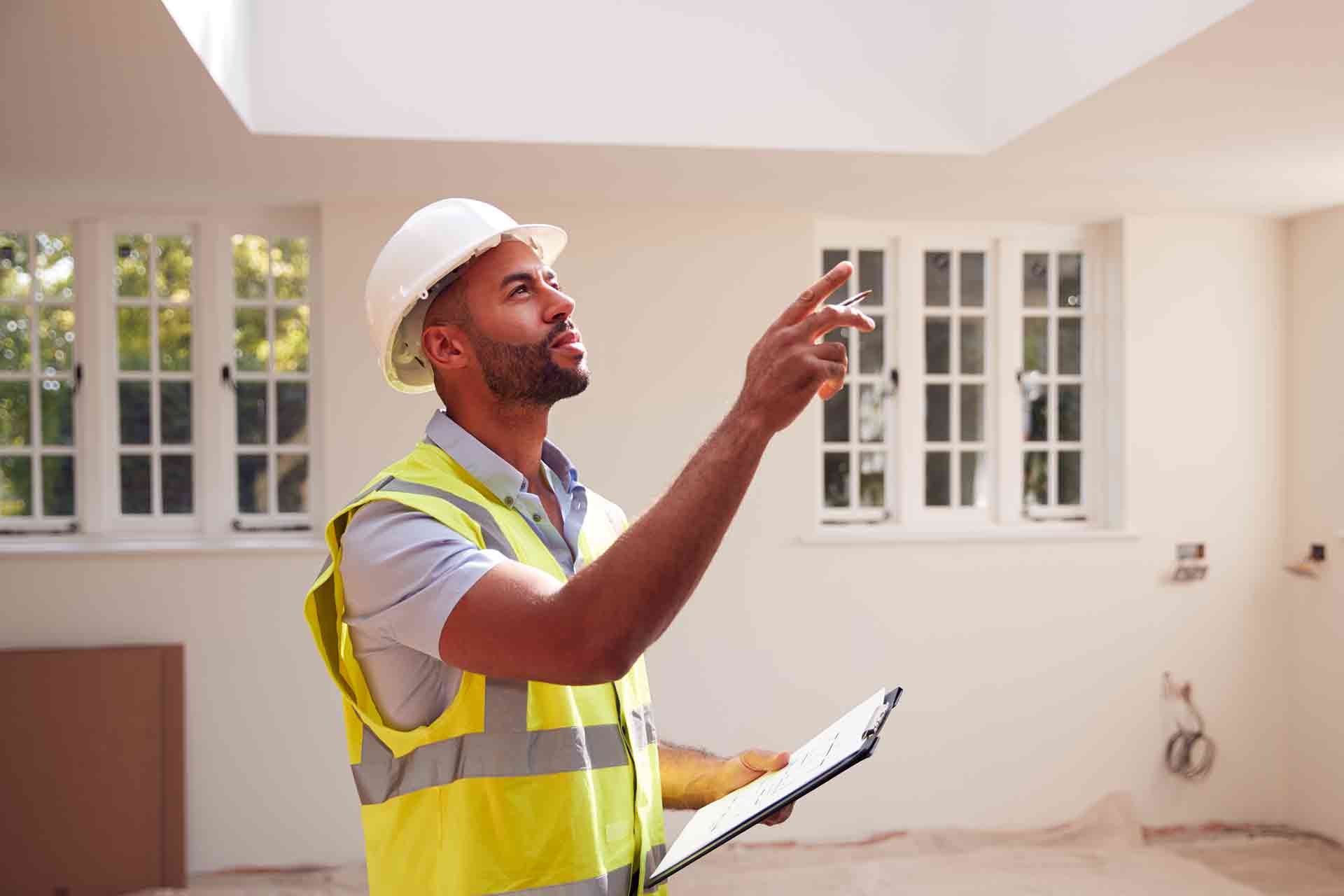 Third Party Wall Surveyors Poole reviewing plans between two parties during a dispute